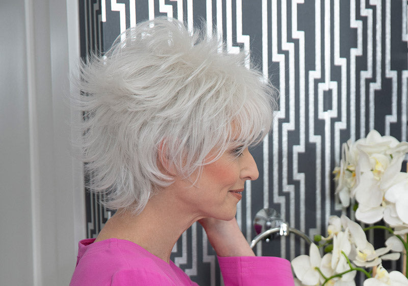 headshot of model wearing golden chin length wig