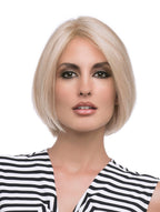 headshot of model wearing blonde chin length wig