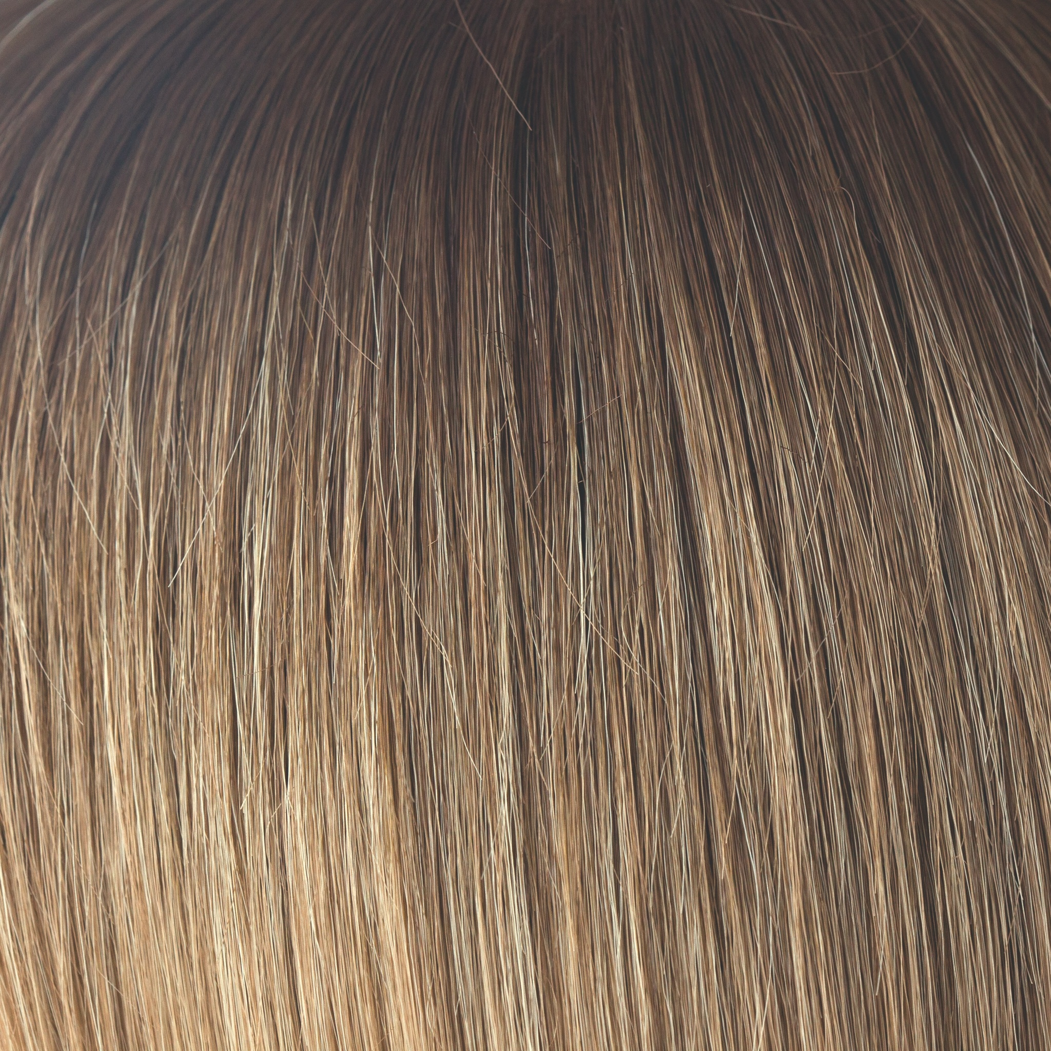 Macadamia-LR  -  The warm rich ombre of the macadamia brown roots blend through into soft, golden blond and walnut cream slices. With a luxury, velvet finish, Macadamia-LR looks great in long and mid length styles.